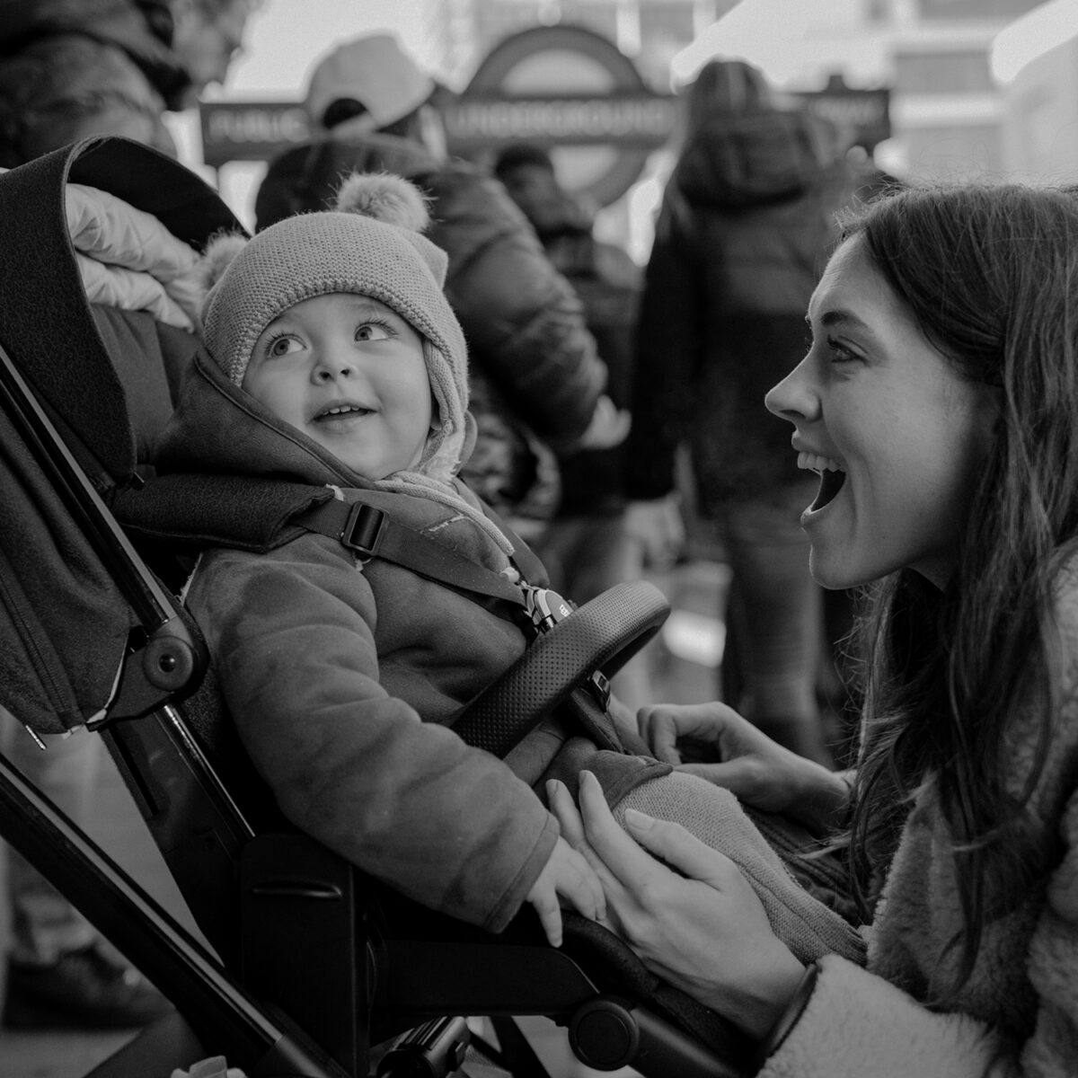 Parents with child sitting in the the pushchair with the seat unit installed.