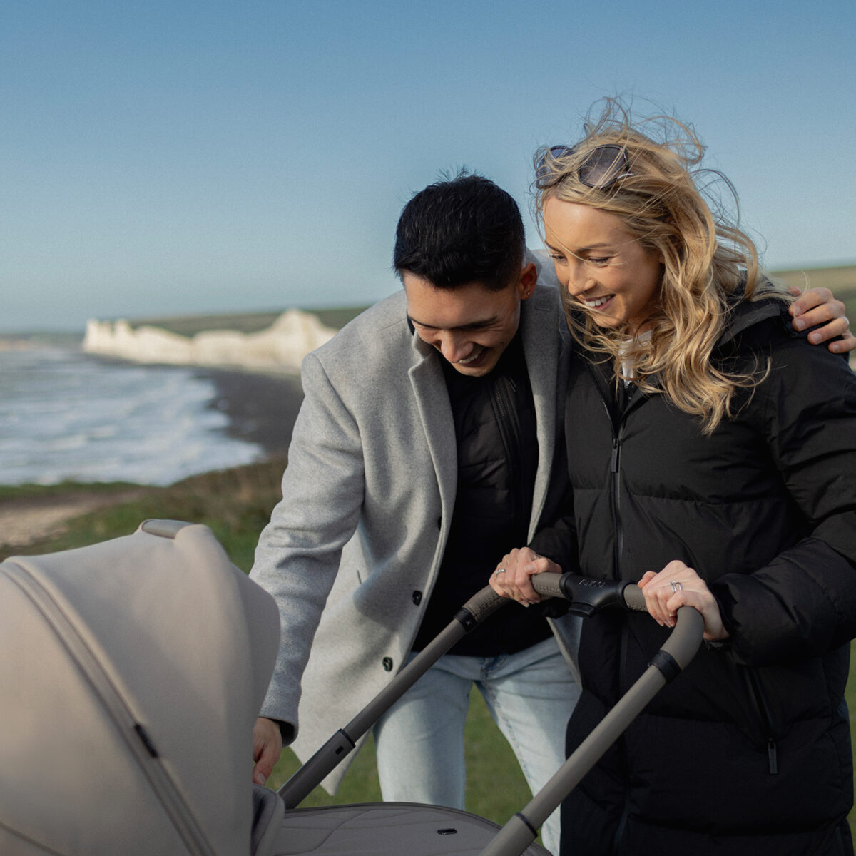 Parents out and about with their venicci upline 2 pushchair & carrycot - close up